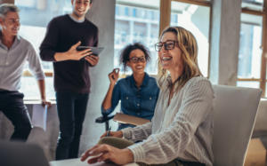 Team laughing together in a bright office during a casual meeting