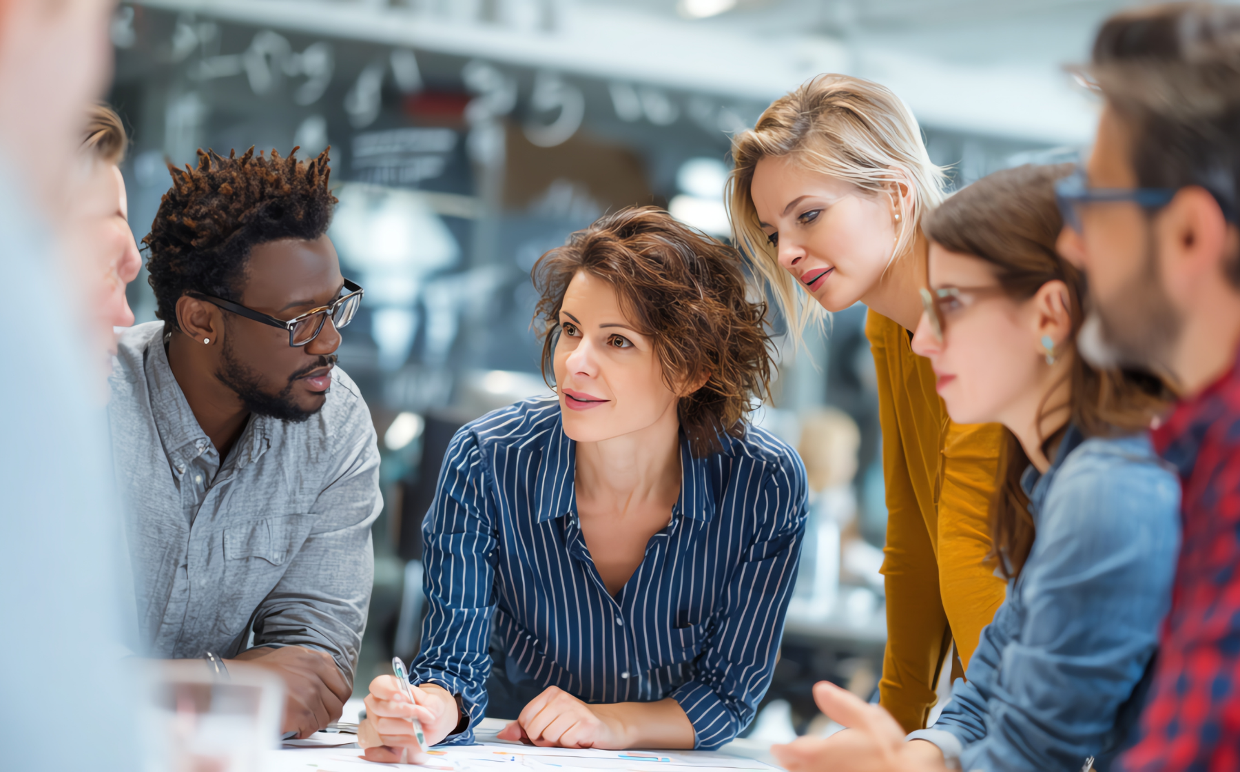 Diverse team collaborating in a modern office meeting