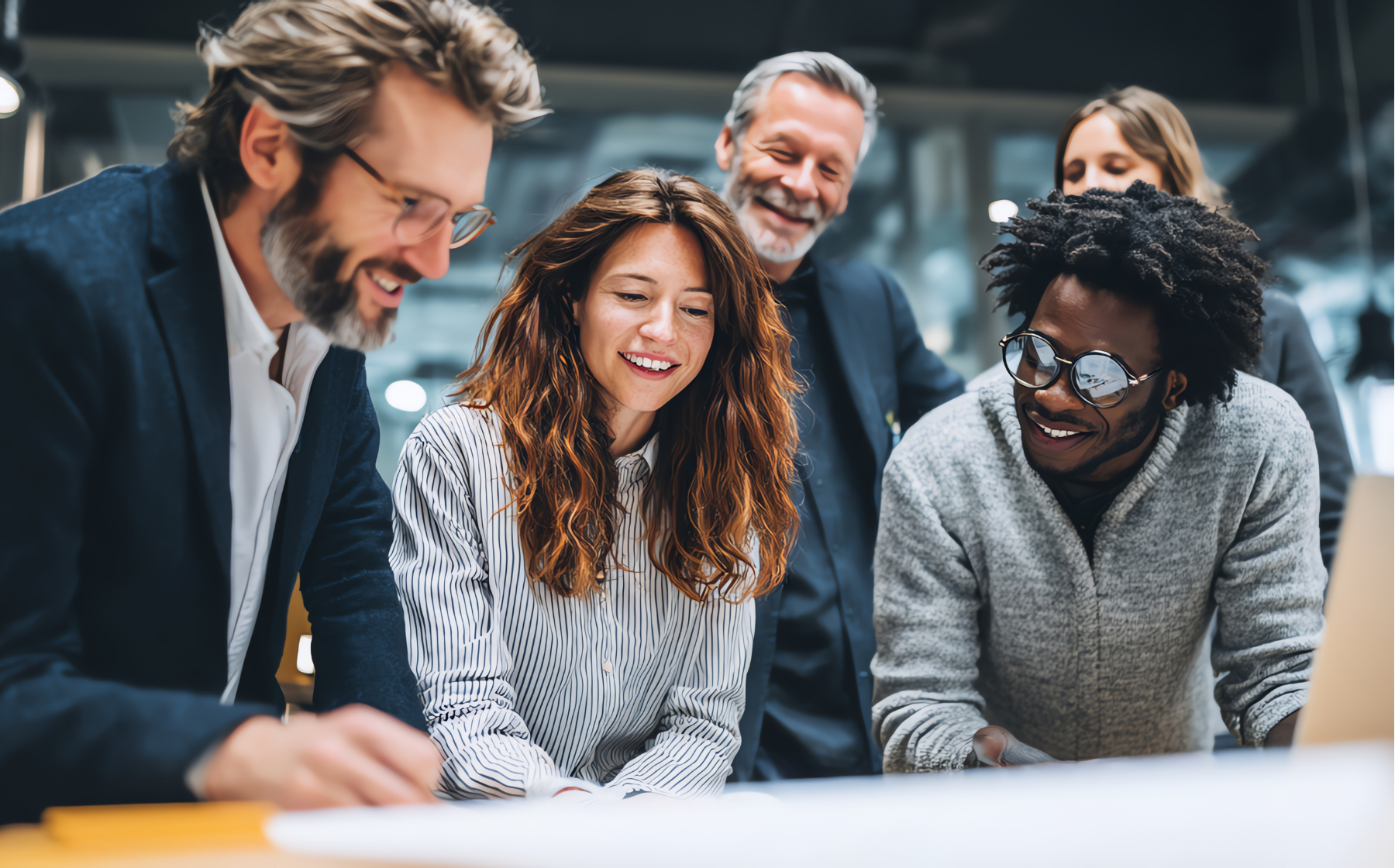 Business professionals smiling during a collaborative discussion