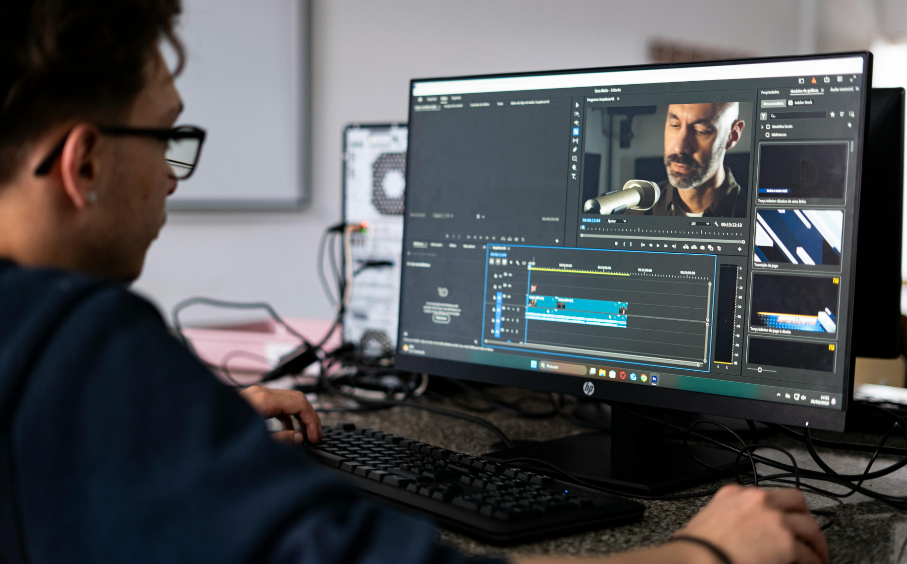Video editor working on editing software at a computer