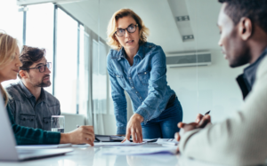Leader guiding a team discussion during a workplace meeting