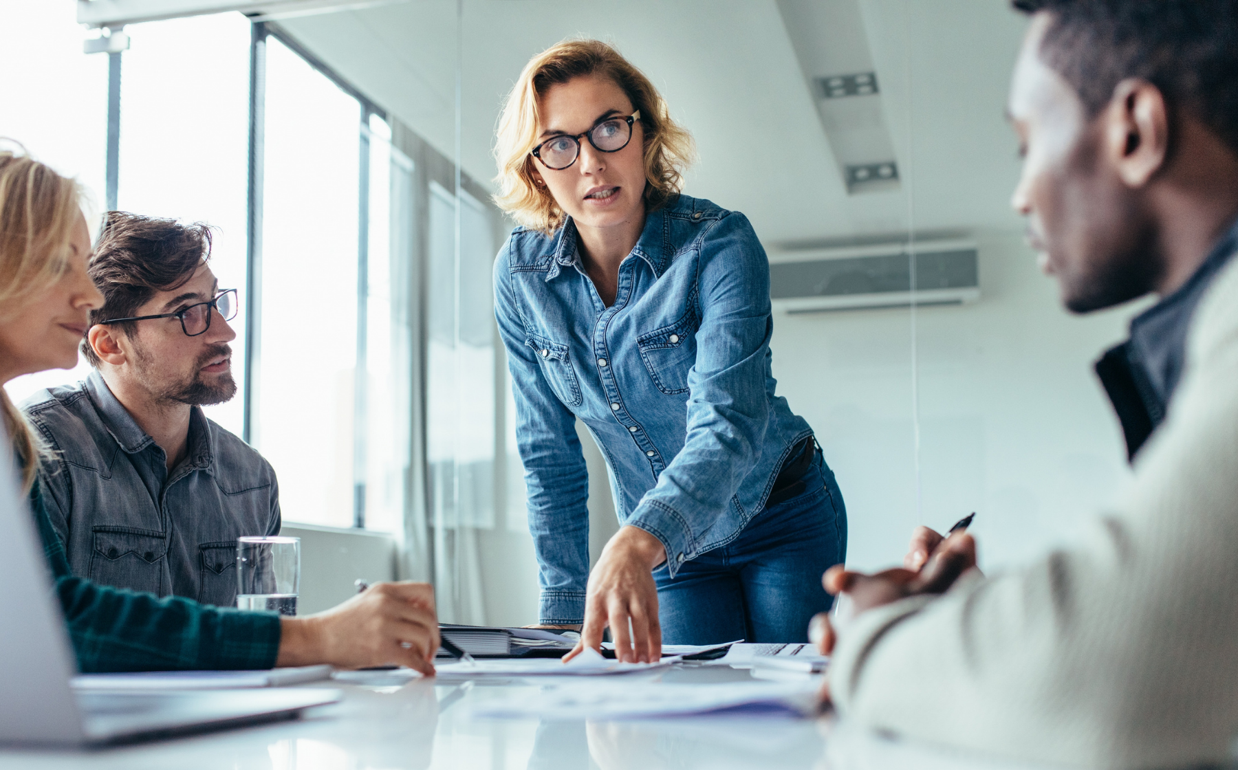 Leader guiding a team discussion during a workplace meeting