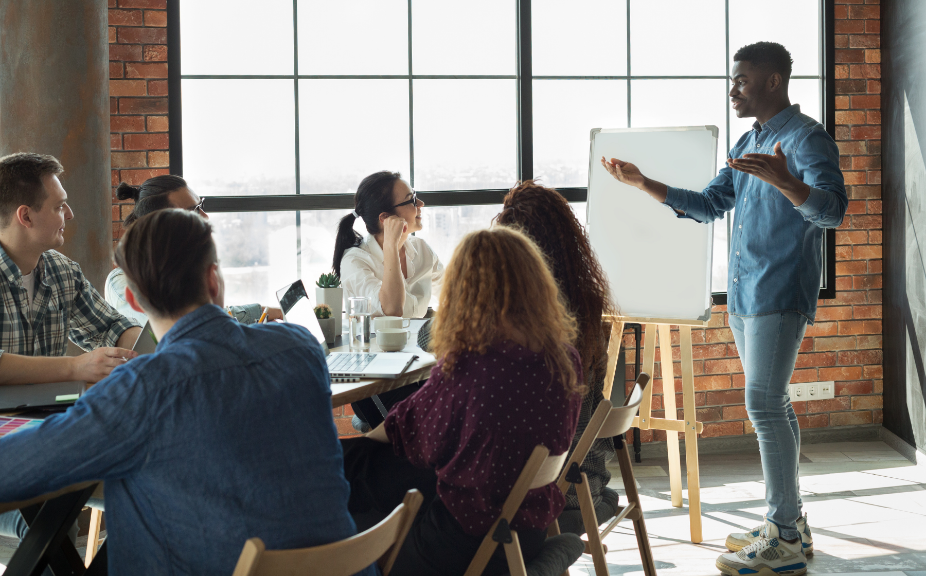 Presenter leading a team discussion in a modern office